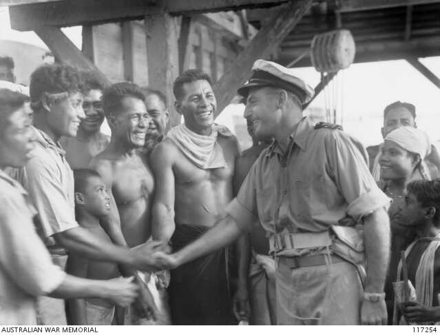 Nauru islanders welcome RAN Lt G. A. Lording after the Japanese surrender.