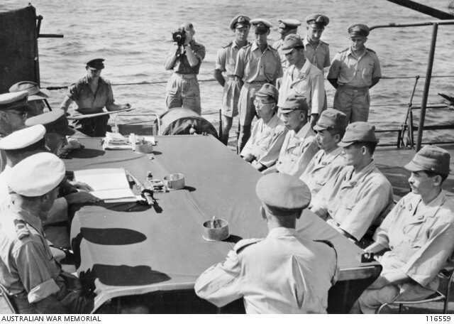 Japanese officers prepare to sign surrender documents on the HMAS Diamantina at Nauru.
