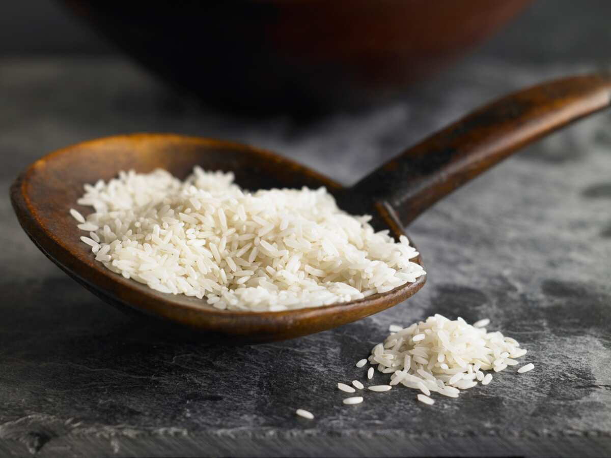 A large spoon filled with rice.