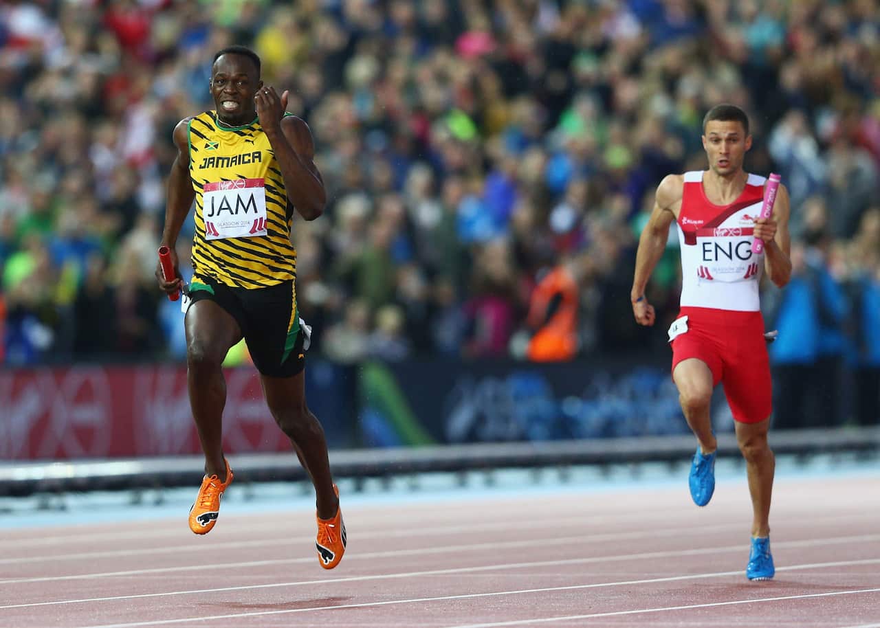 Usain Bolt of Jamaica wins gold ahead of Danny Talbot of England in the Mens 4x100 metres relay final at Hampden Park during the Glasgow 2014 Commonwealth Games, August 2, 2014. (Cameron Spencer/Getty)