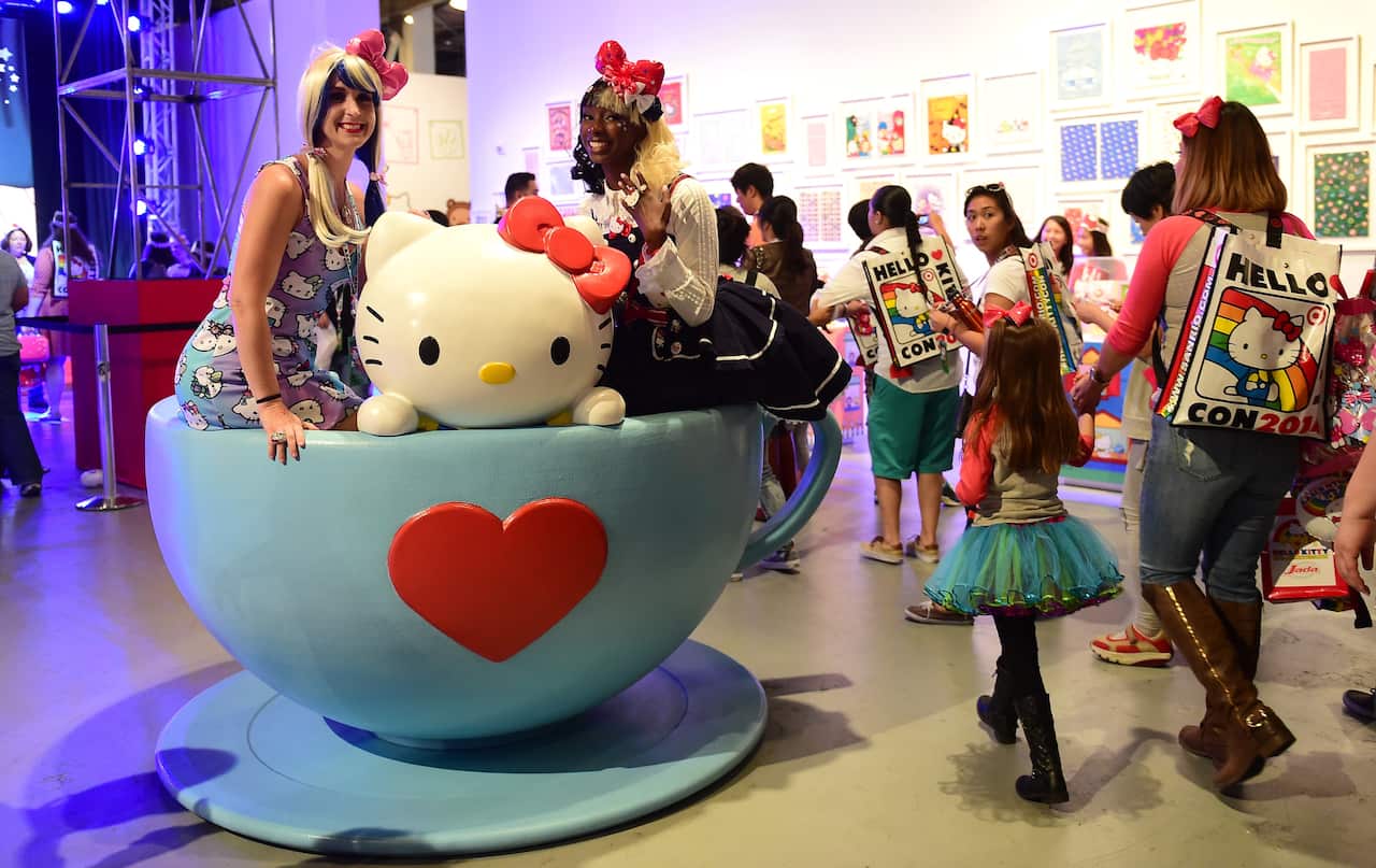 Hello Kitty fans pose for photos in a giant tea cup at the Hello Kitty Con, the first-ever Hello Kitty fan convention