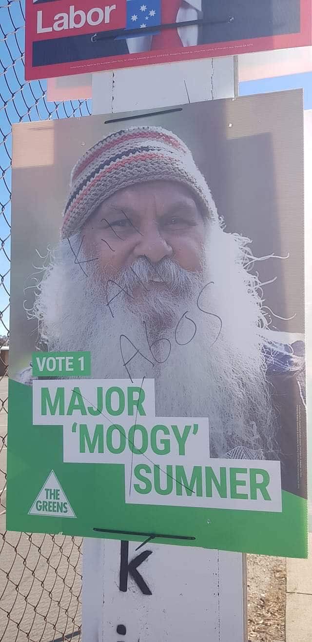 A campaign poster for Major 'Moogy' Sumner was defaced with racist slogans.