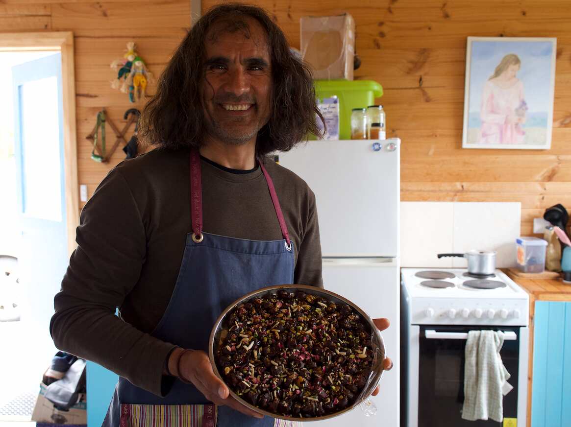 Arad Niksefat at his home, preparing his food to sell at market.