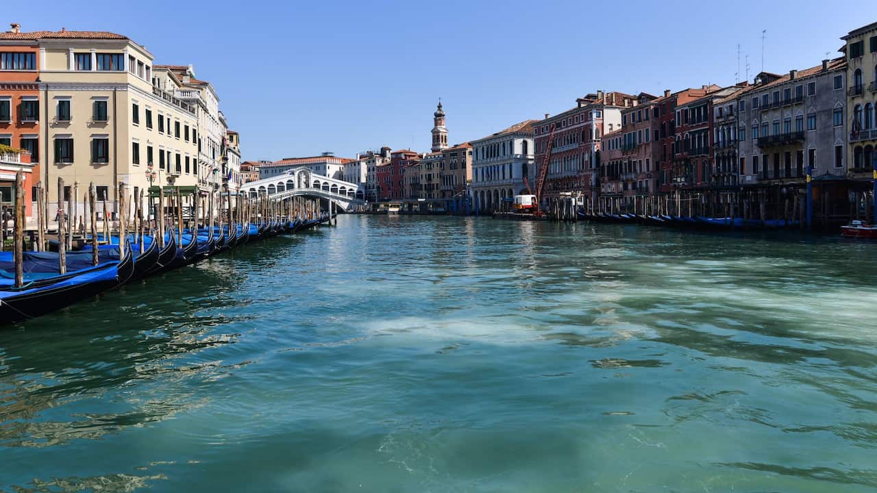 Clear waters of the Grand Canal near the Rialto Bridge in Venice.