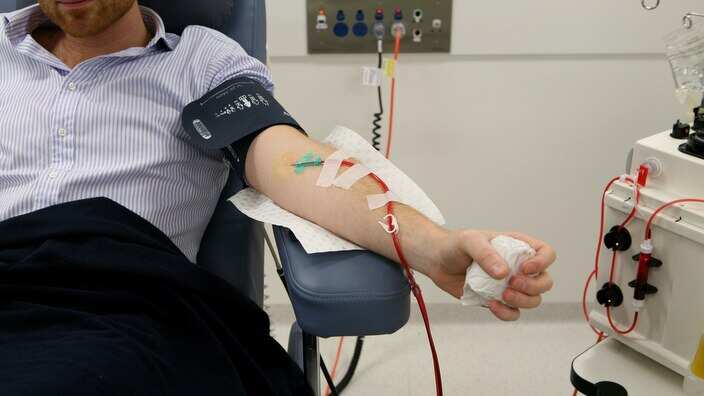 A person gives a blood donation. 