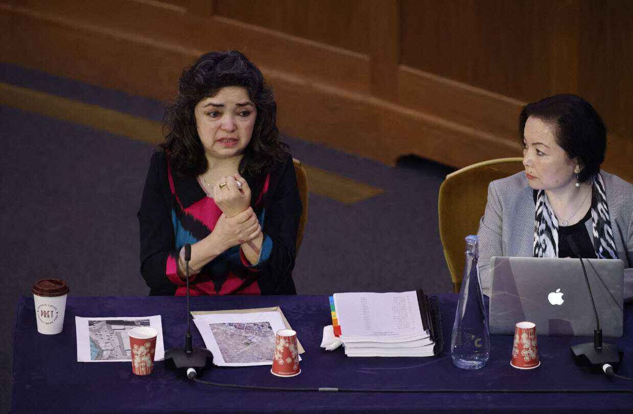 Uighur teacher Qelbinur Sidik (L) gestures as she speaks on the first day of hearings at the "Uighur Tribunal".
