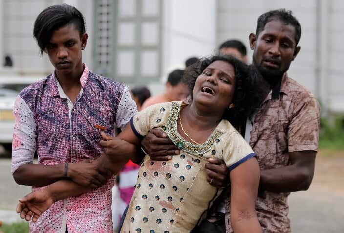 Relatives of a blast victim grieve outside a morgue in Colombo, Sri Lanka, Sunday, April 21, 2019.