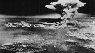 A mushroom cloud billows one hour after the bombing of Hiroshima. 