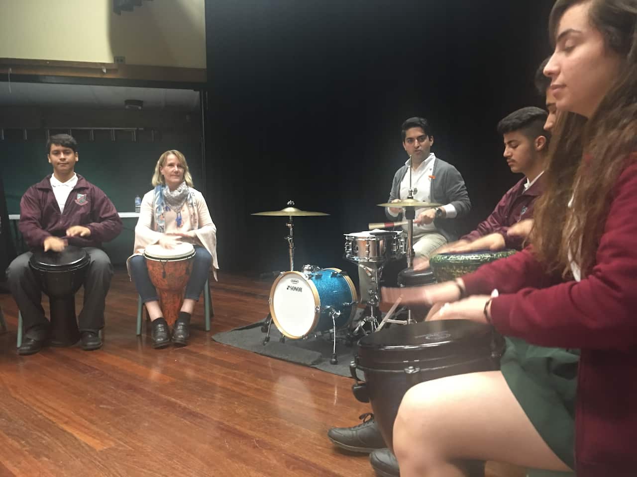 Evan Yako teaches drumming to newly arrived migrants and refugees.