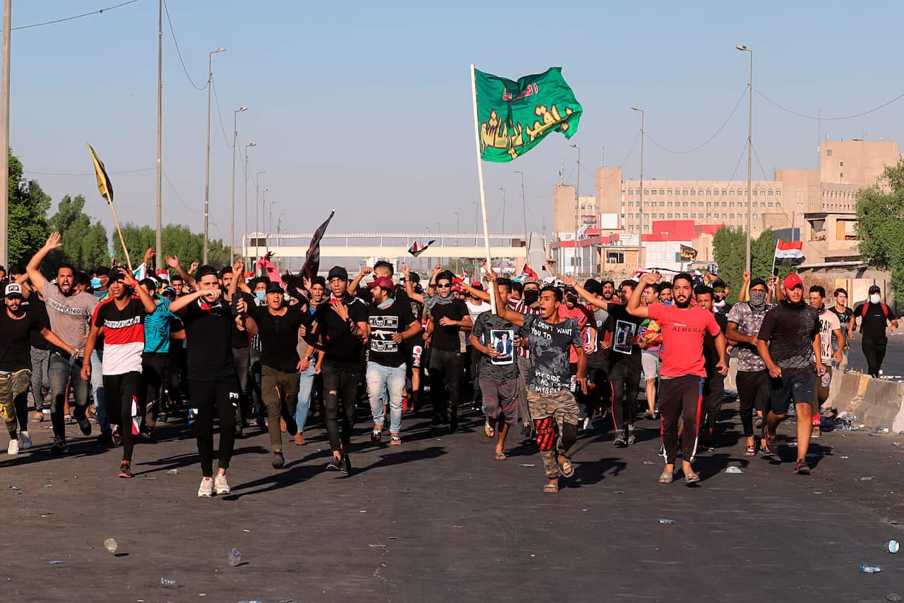 Anti-government protesters chant slogans during a demonstration in Baghdad, Iraq