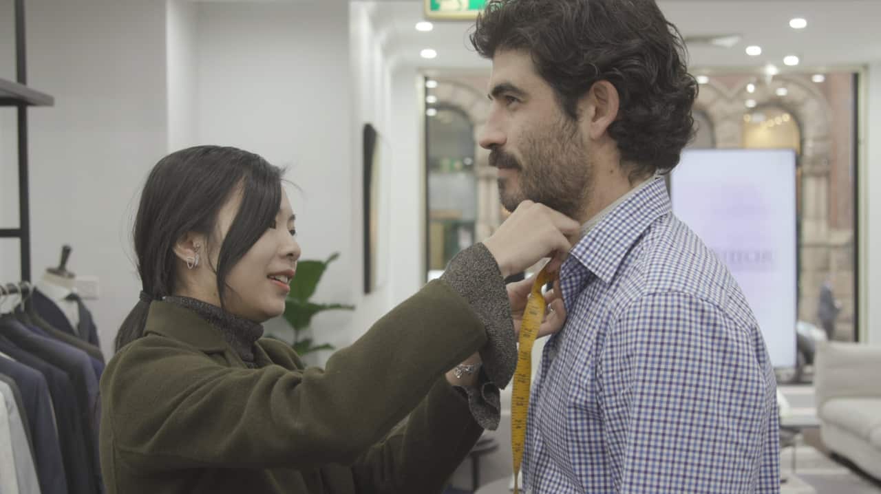 A customer having his measurements taken at Institchu's Sydney (Clarence St) showroom.