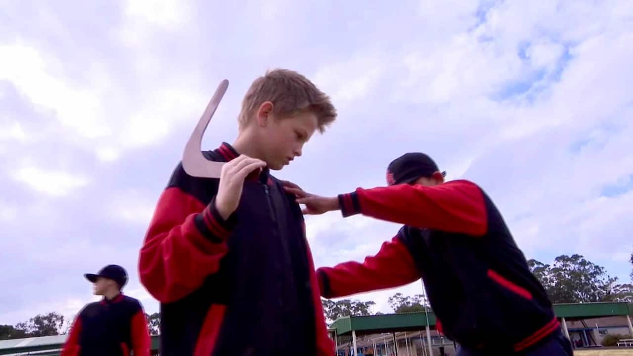 Student learning how to throw a boomerang.