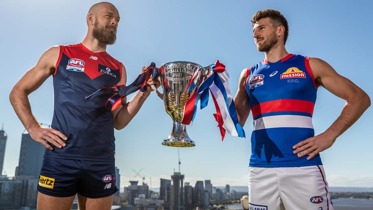Max Gawn (L) captain of the Demons and Marcus Bontempelli, captain of the Bulldogs holding the 2021 AFL Premiership Cup after an AFL Grand