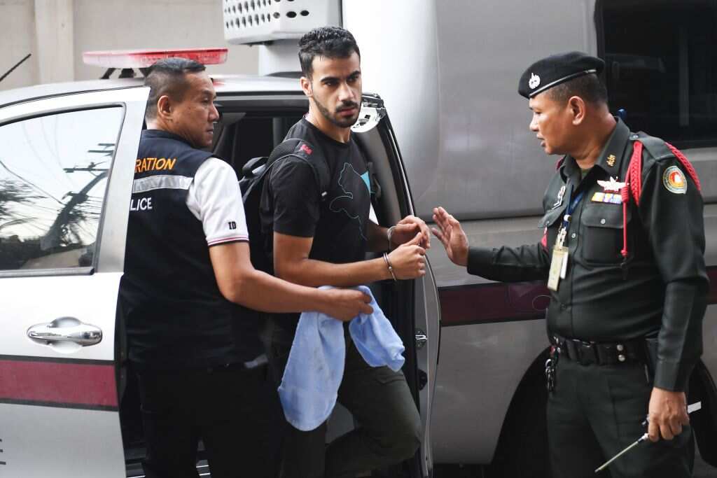 The former Bahrain national team footballer with refugee status in Australia, is escorted by immigration police to a court in Bangkok.
