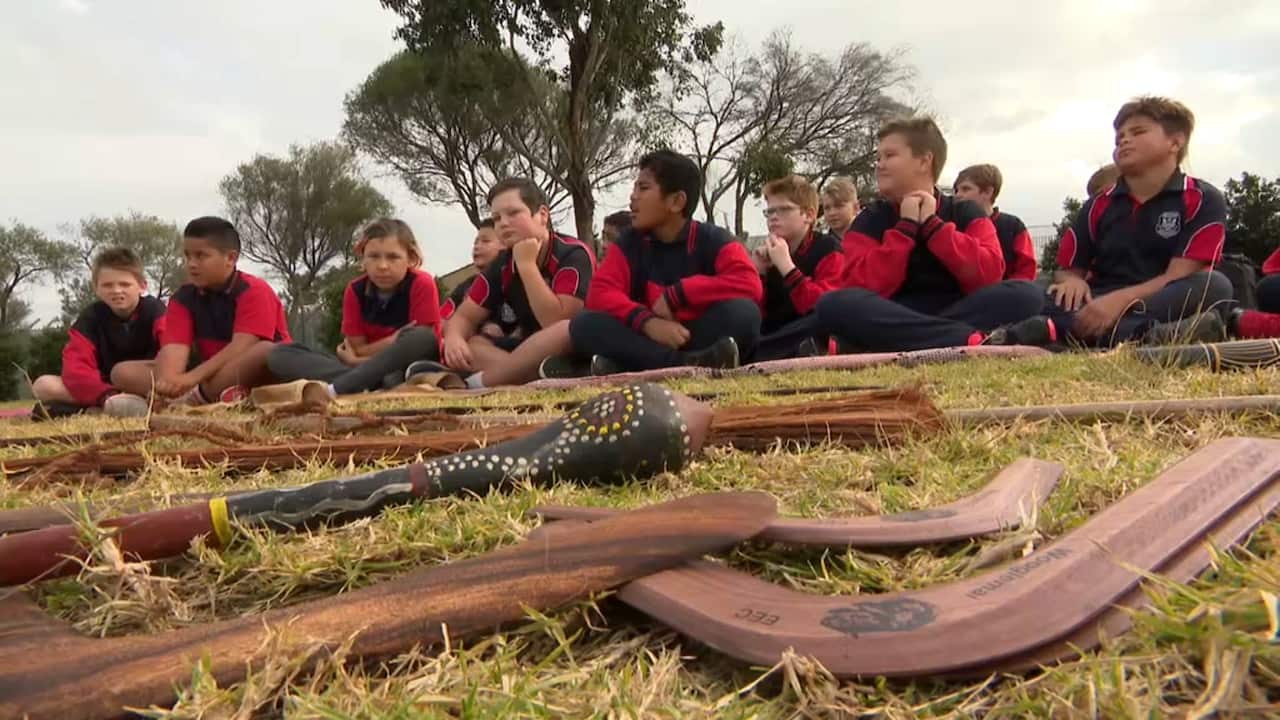 Students learning about traditional tools and weapons.