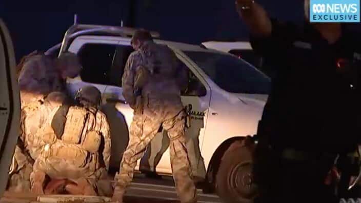 Members of the Territory Response Group arrest a suspected gunman in Darwin. 