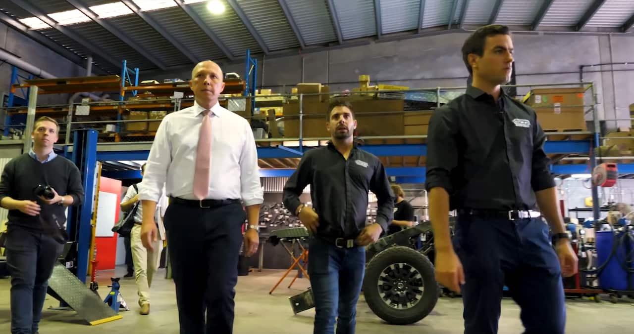 Peter Dutton visiting the car dealership.