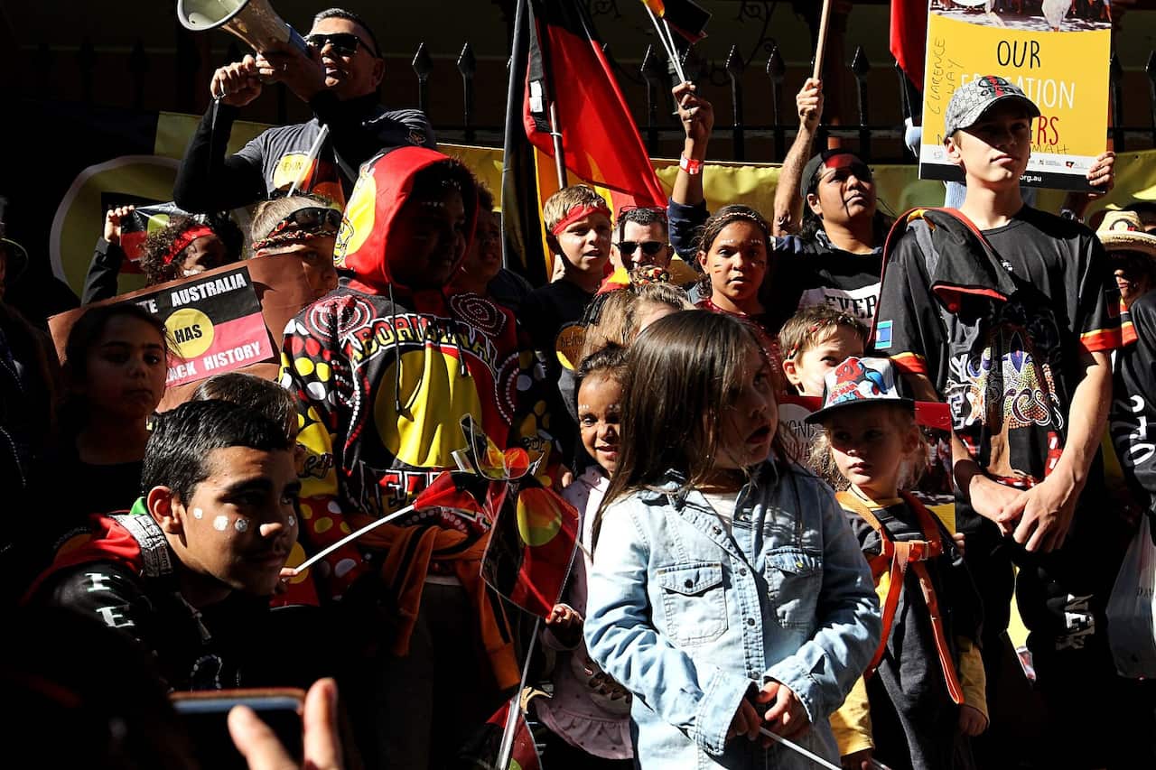 Roy Ah-See rallies the crowd outside Parliament House in Sydney.