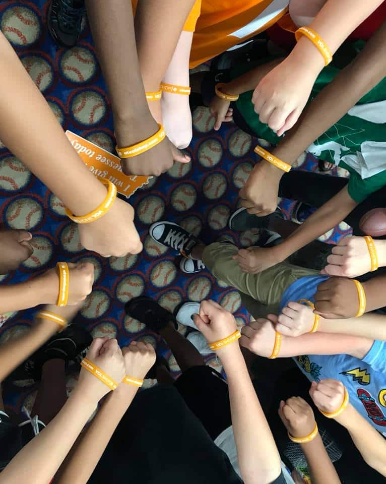 The boy shared the merchandise with his classmates.