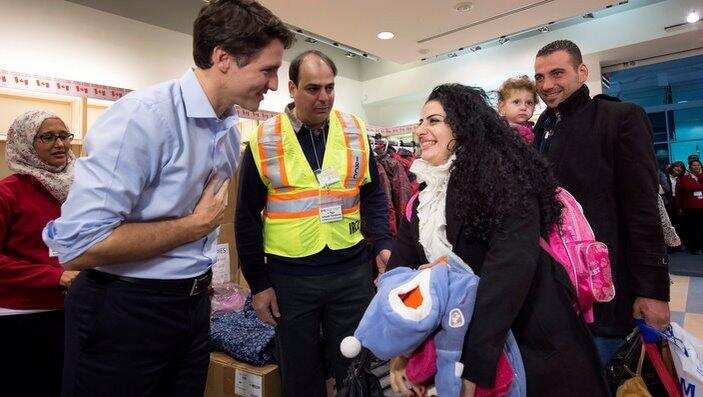 Canadian Prime Minister Justin Trudeau greets refugees fleeing from Syria