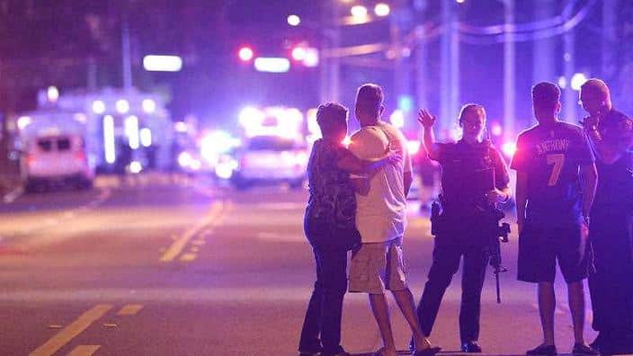 Orlando Police officers direct family members away from a fatal shooting at Pulse Orlando nightclub