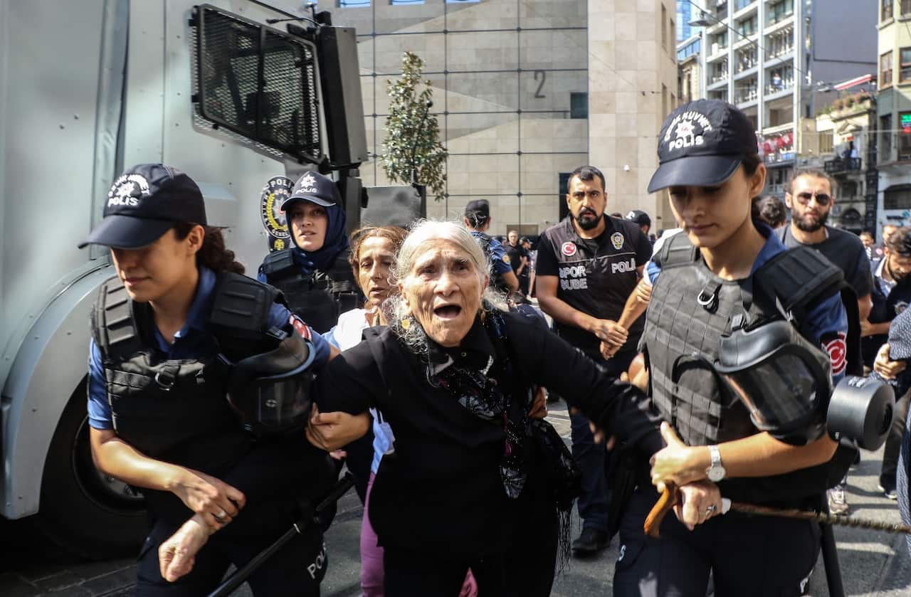 Emine Ocak, a a member of Saturday Mothers Turkish group is detained by Turkish female riot police during a demonstration on August 25, 2018 in Istanbul.