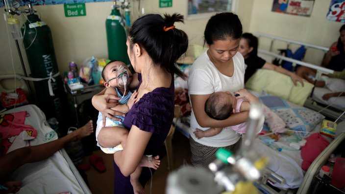 Filipino children, who are suffering from measles, share beds at a hallway of an over crowded government hospital in Manila.