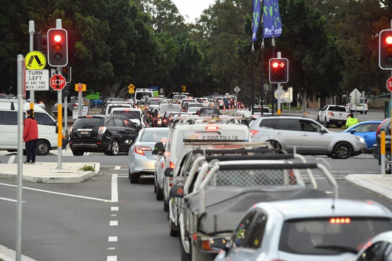 Long queues of cars are seen at a pop up COVID testing clinic at the Fairfield Showgrounds in Sydney. 