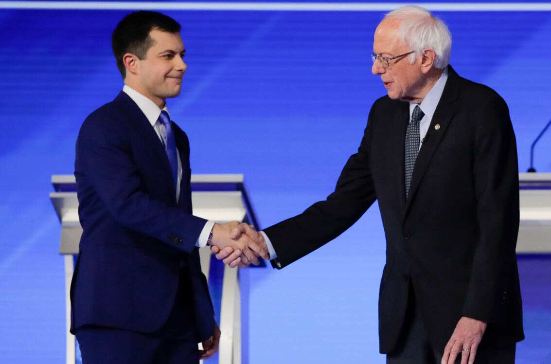 Pete Buttigieg and Bernie Sanders before the start of the Democratic presidential primary debate 