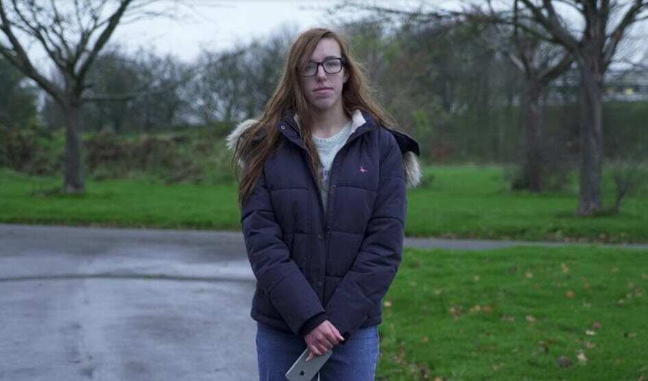 Nineteen-year-old student Leila Hay, who used to believe the the coronavirus pandemic was a hoax, poses for a photograph near her apartment in Hull, Britain.