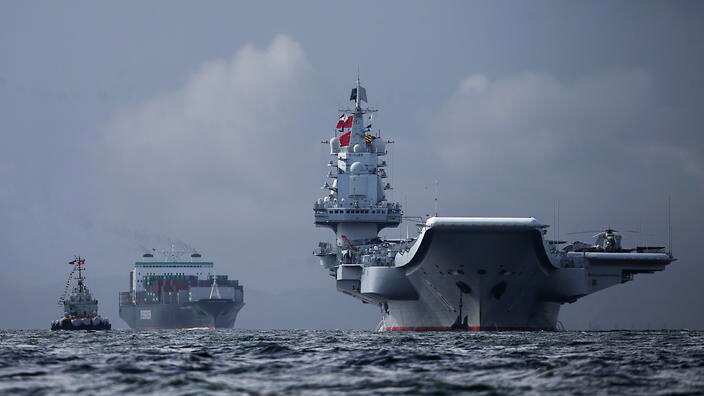 The Liaoning (R), the first aircraft carrier commissioned into China's military, arrives in Hong Kong on July 7. (EPA) 