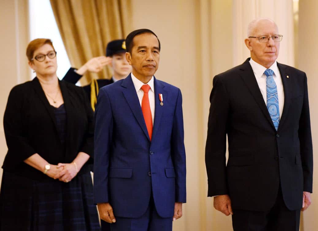 Joko Widodo (centre) receives a ceremonial welcome at Government House