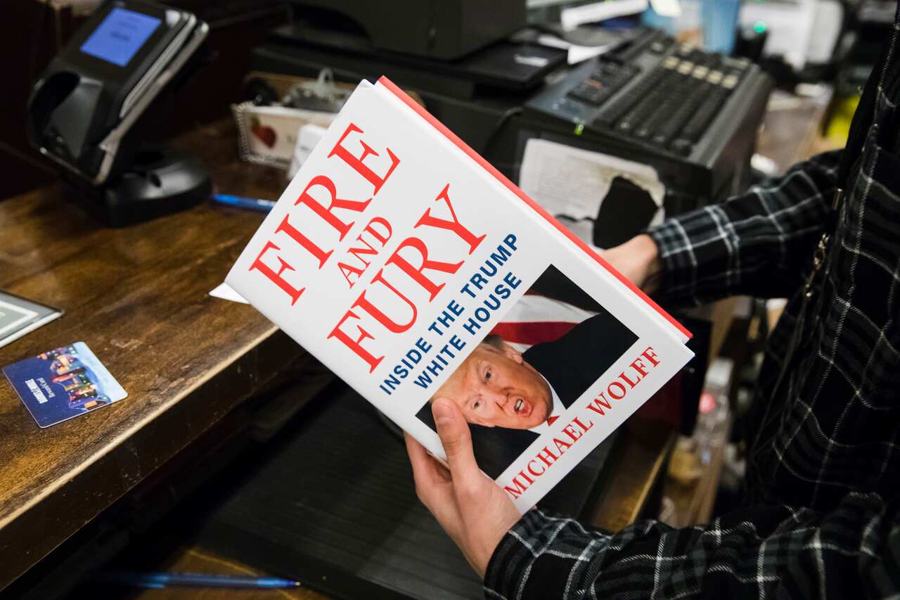 A salesperson with a copy of the book Fire and Fury: Inside the Trump White House in Philadelphia.