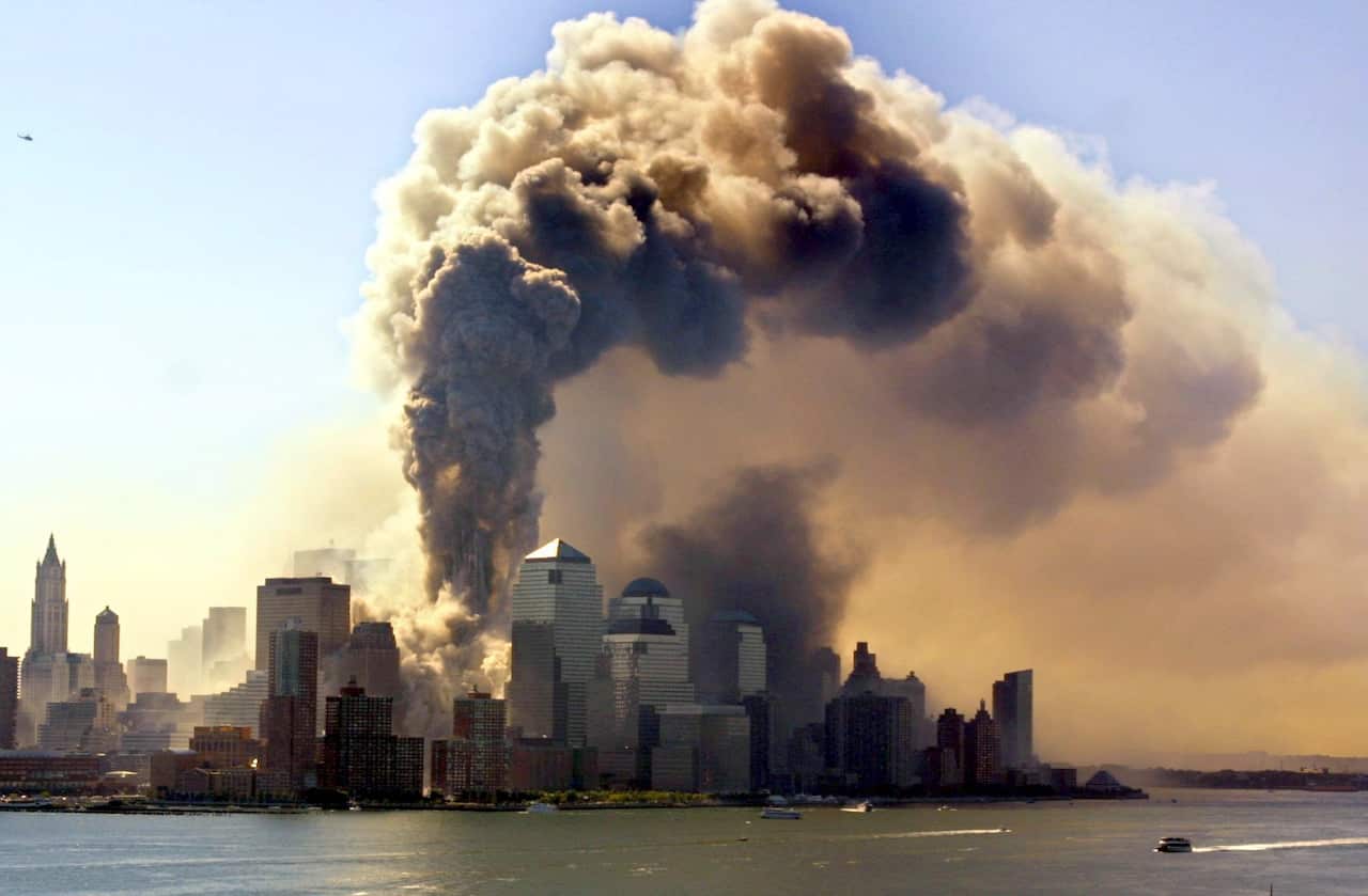 An archive photo taken on September 11 2001, shows thick smoke rises from the burning twin towers of the World Trade Centre.