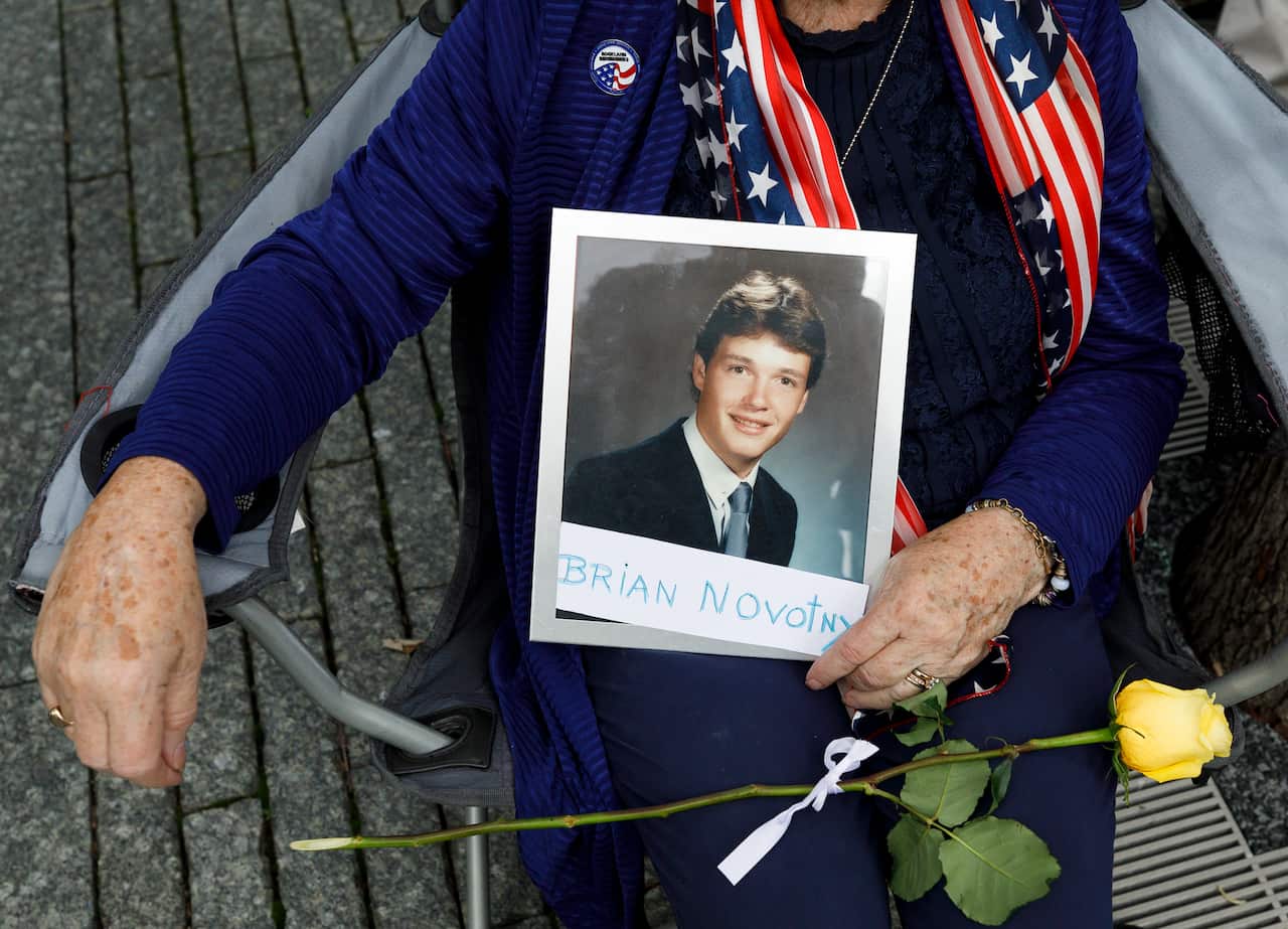 At the National September 11 Memorial, Mary Novoty, of New York holds a picture of her son, Brian, who was killed at the World Trade Centre.