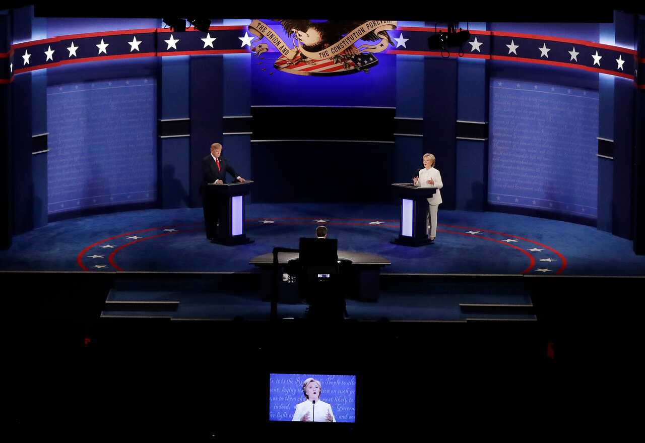 Democratic presidential nominee Hillary Clinton and Republican presidential nominee Donald Trump debate during the third presidential debate at UNLV in Las Vegas, Wednesday, Oct. 19, 2016. (AP Photo/Julio Cortez)