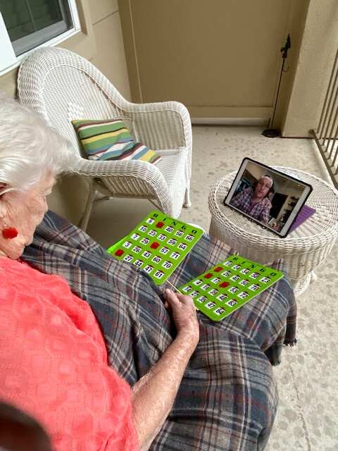 A resident at The Enclave plays bingo live with Matthew McConaughey.