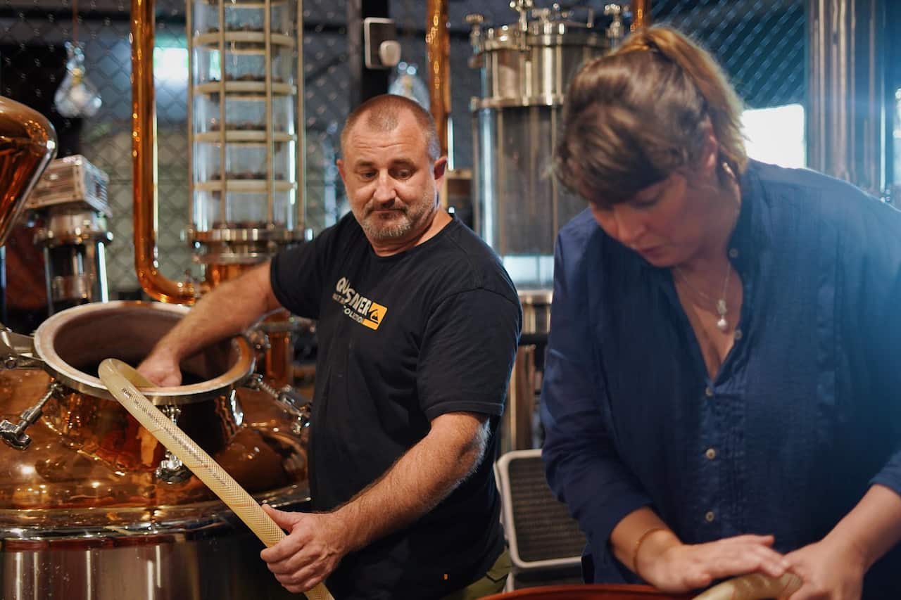 Heath Russell and Bec Bullen working with the ferment which makes hand sanitiser