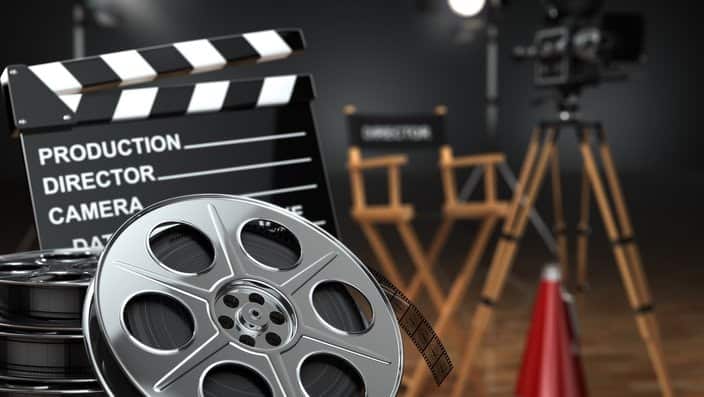 Video, movie, cinema concept. Retro camera, reels, clapperboard