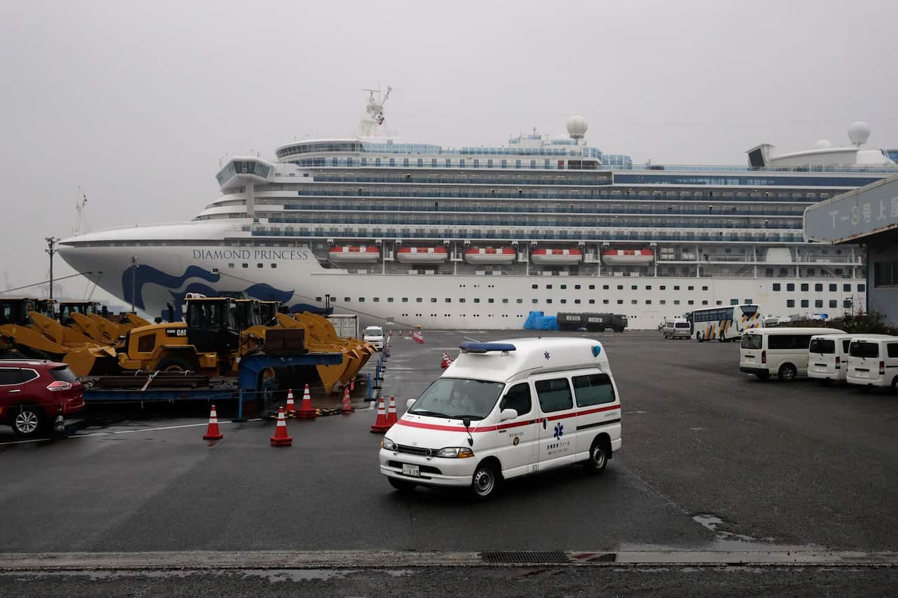 An ambulance leaves a port where the quarantined Diamond Princess cruise ship is docked Sunday, Feb. 16, 2020, in Yokohama, near Tokyo. 