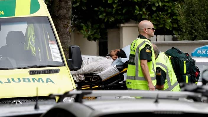 Ambulance staff take a man from outside a mosque in central Christchurch, New Zealand