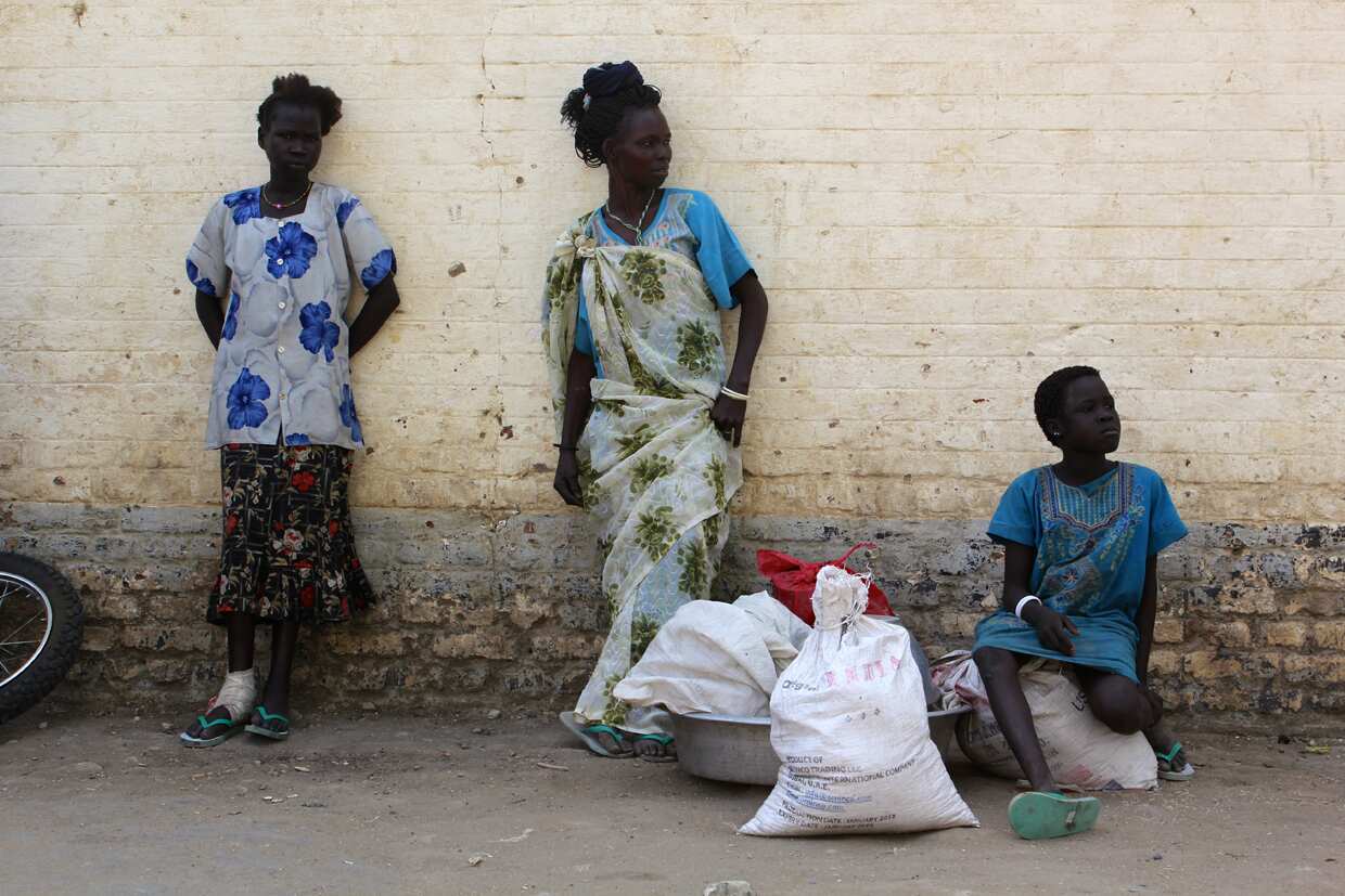 South Sudanese women stand in Malakal hospital grounds. Thousands have been squeezed into the church grounds as fighting displaces up to 500,000 people. (Source: Ilya Gridneff)