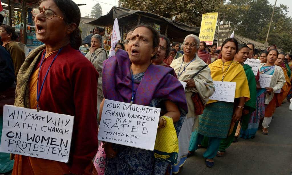 Women activists carry posters as they shout slogans during a protest march against the gangrape and murder of a teenager, in Kolkata on January 3, 2014.