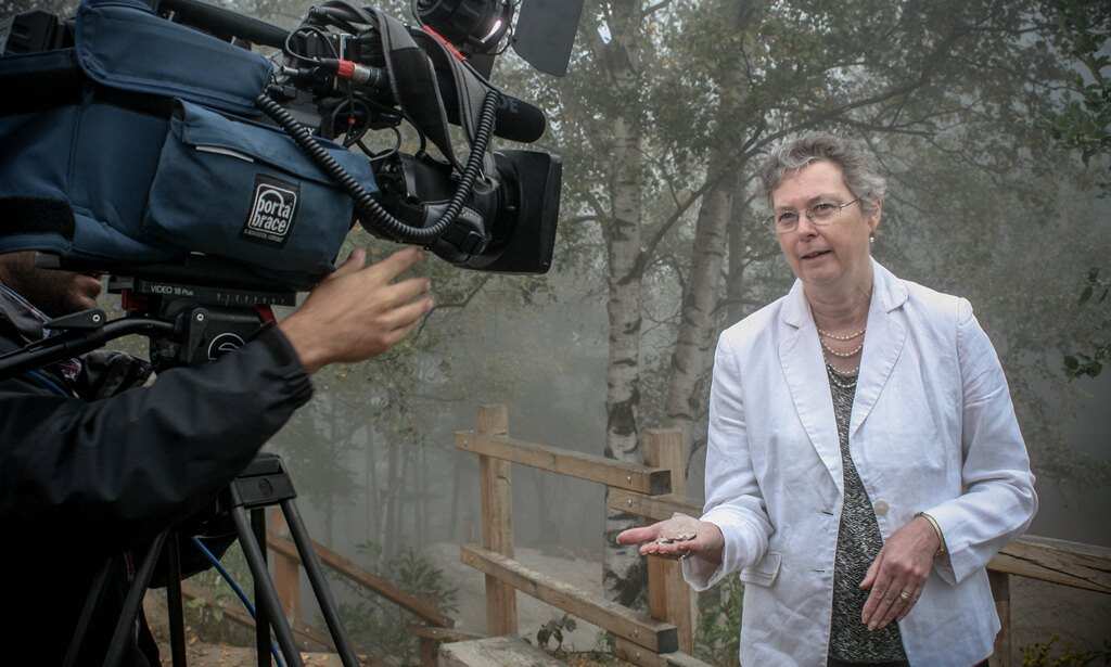 Kathy Hind shows debris from Clarence Lawton’s aircraft.