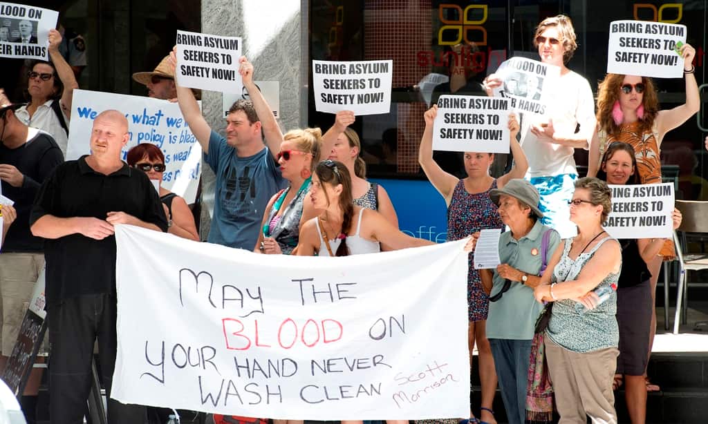 Protestors are seen outside the Immigration Deprtment building in Brisbane, Wednesday, February 19, 2014. One aslyum seeker died and others were treated for serious injuries following violence at the Manus Island detention centre on Monday.
