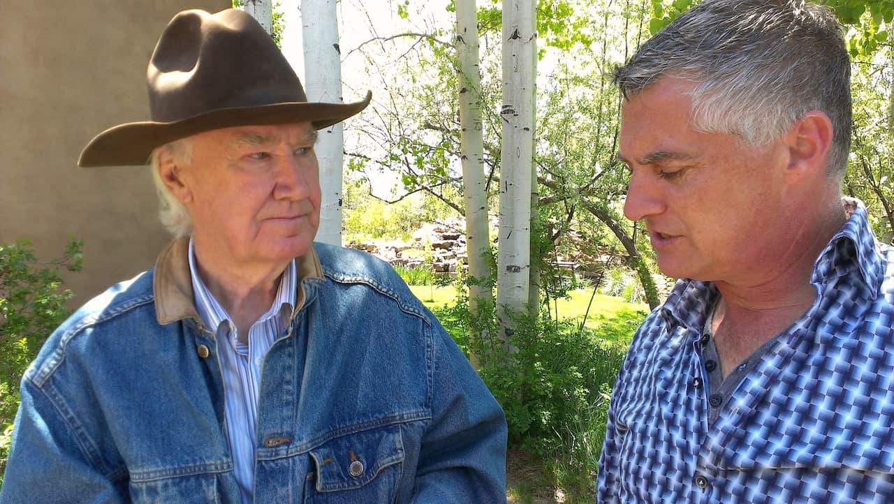 SBS Dateline reporter Nick Lazaredes with millionaire Forrest Fenn who claims to have hidden buried treasure in the mountains north of Sante Fe. (SBS)