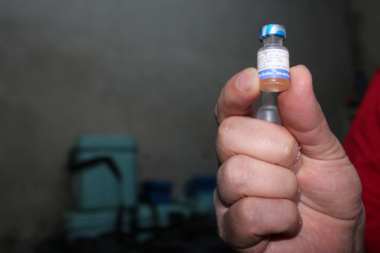Oral polio vaccination: in order for it to be efficient, it must be stored between 2-8 degrees and children receive two drops. The front of houses in Aleppo are marked if children have had the vaccine. (Photo: Sophie Cousins)