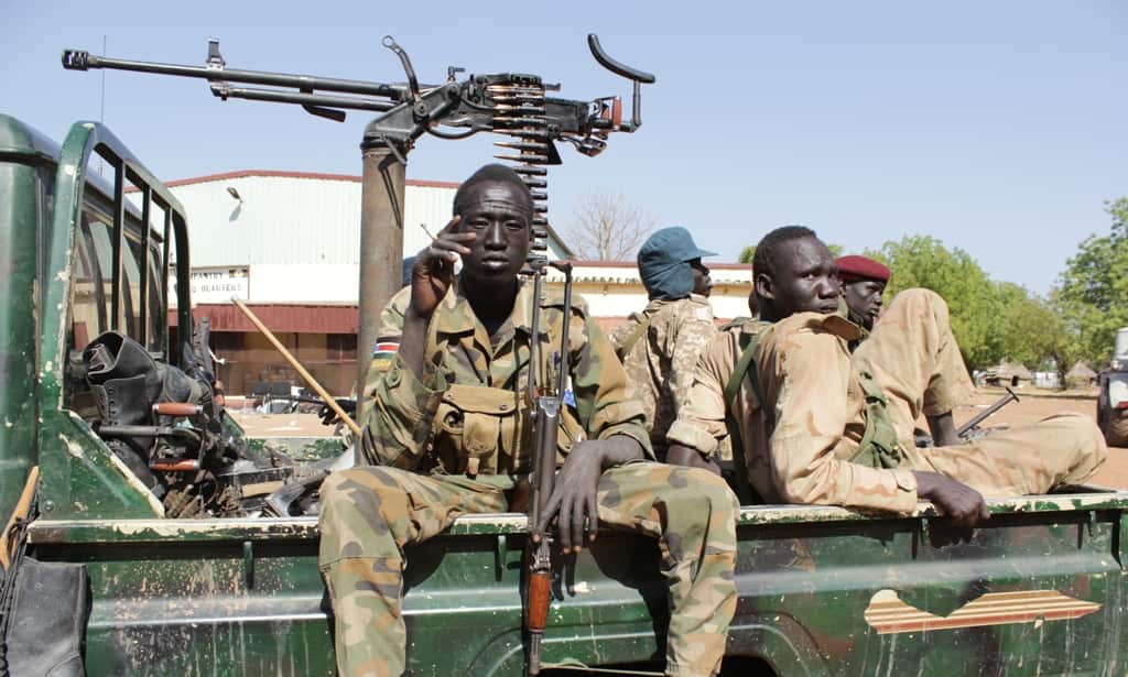 Soldiers from South Sudan army relax after heavy fighting in Bentiu, Unity State. More than 700,000 people have fled their homes and 79,000 have sought refuge in United Nations compounds. (Source: Ilya Gridneff)