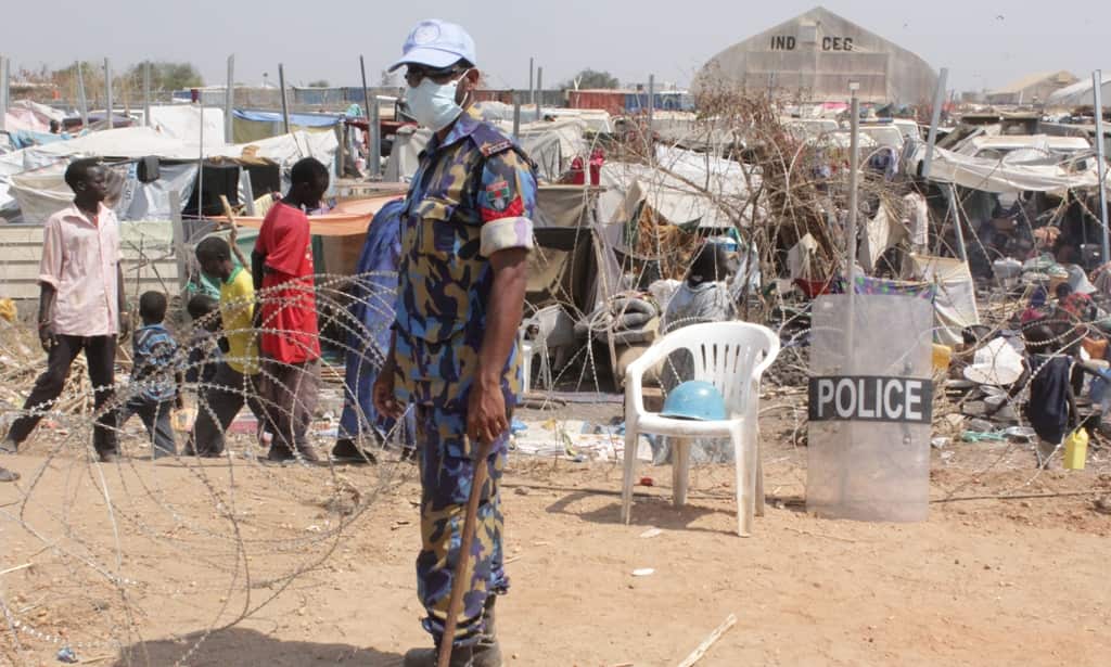 A Bangladeshi police officer attached with the United Nations in Malakal supervises some of the 27,000 people who have sought refuge in the compound. (Source: Ilya Gridneff)