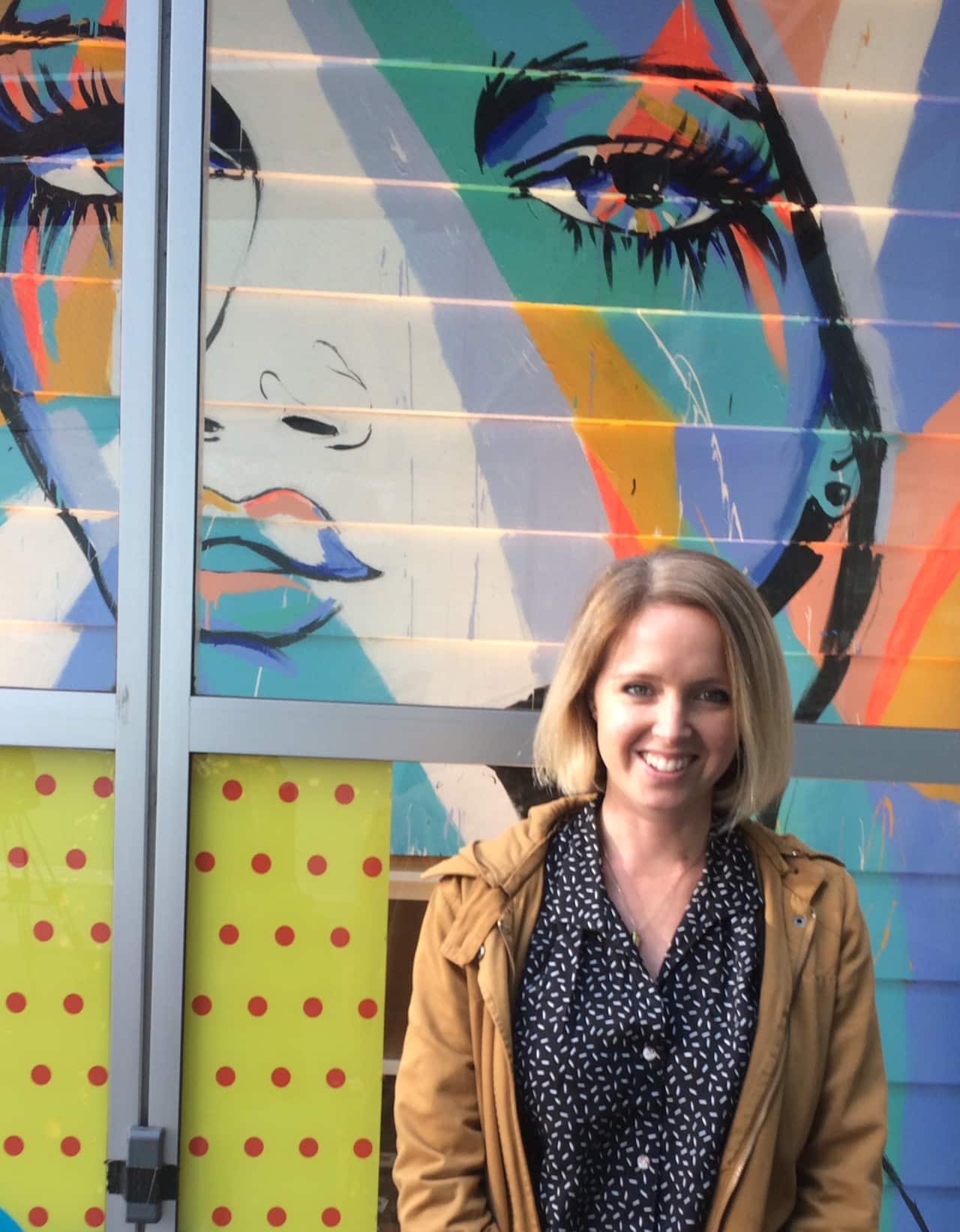 Sydney street artist, Anya Brock, with her art, displayed at Glue clothes store in Sydney's Bondi Junction (Photo: Brianna Roberts)